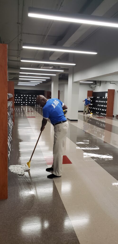 owner mopping store tile floor