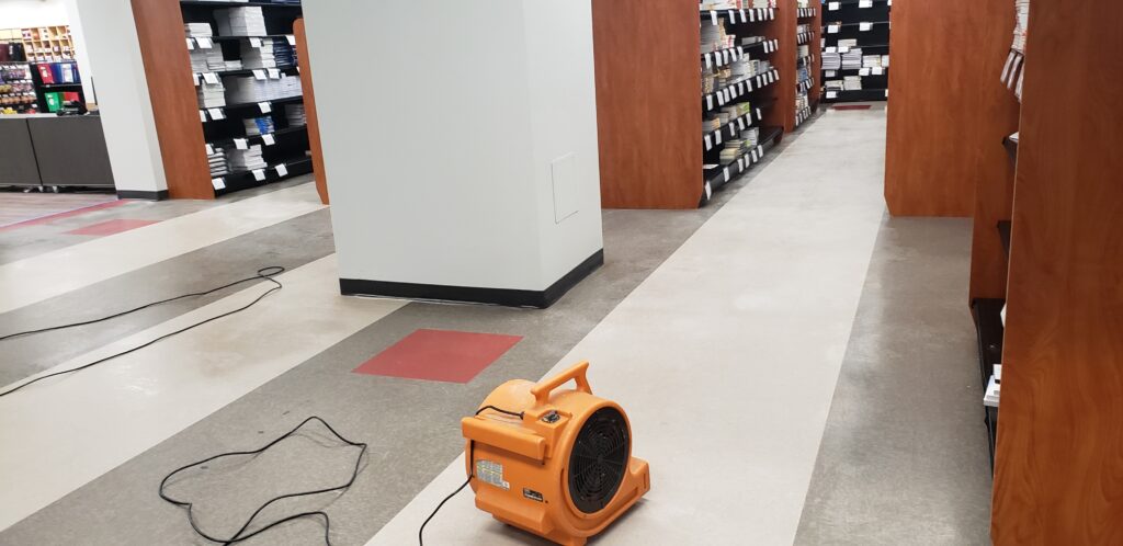 setting up to clean store dirty floor
